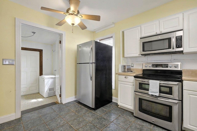 1195 Alligator Dr, Alligator Point, FL 32346 - kitchen featuring appliances with stainless steel finishes, white cabinets, light countertops, and baseboards