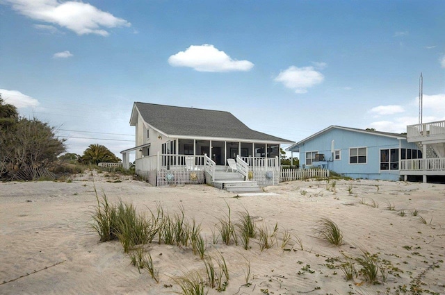 1195 Alligator Dr, Alligator Point, FL 32346 - back of property featuring a sunroom and roof with shingles