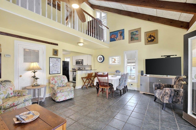 1195 Alligator Dr, Alligator Point, FL 32346 - living area with high vaulted ceiling, plenty of natural light, beam ceiling, baseboards, and a ceiling fan