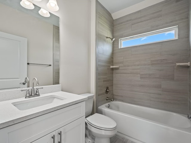 full bathroom with toilet, tiled shower / bath combo, and vanity