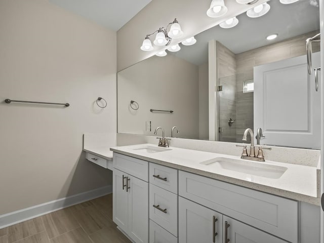 bathroom with a shower with shower door and vanity