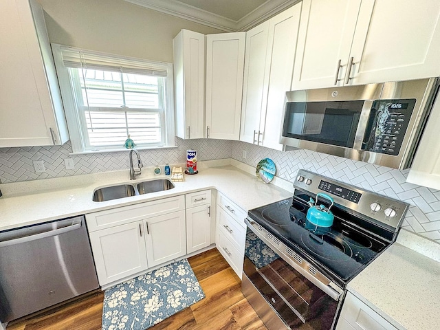 254 Ante Beppum Loop, Carrabelle, FL 32322 - kitchen with appliances with stainless steel finishes, ornamental molding, white cabinetry, tasteful backsplash, and light countertops