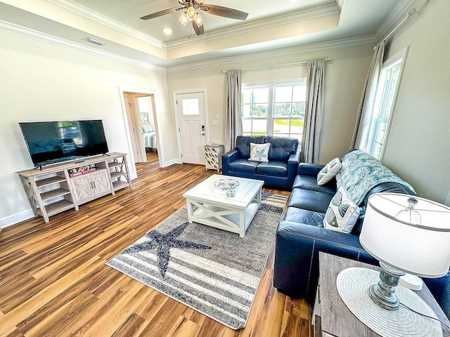 254 Ante Beppum Loop, Carrabelle, FL 32322 - living area featuring a tray ceiling, wood finished floors, ornamental molding, and a ceiling fan