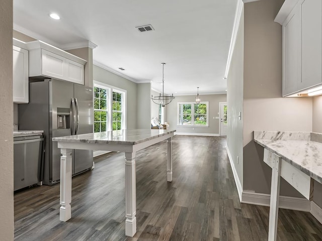 kitchen with a wealth of natural light, white cabinets, and stainless steel appliances