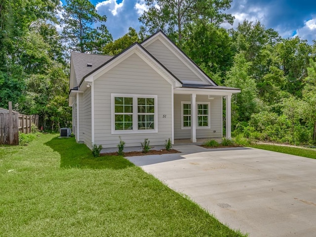 view of front of home with central air condition unit and a front lawn