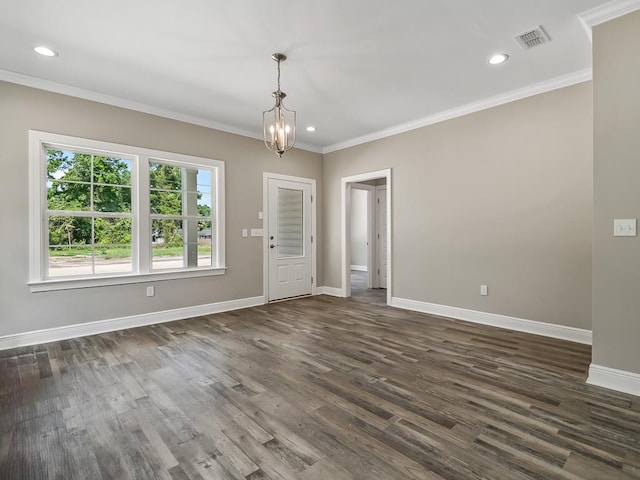 unfurnished room with dark hardwood / wood-style flooring, crown molding, and an inviting chandelier