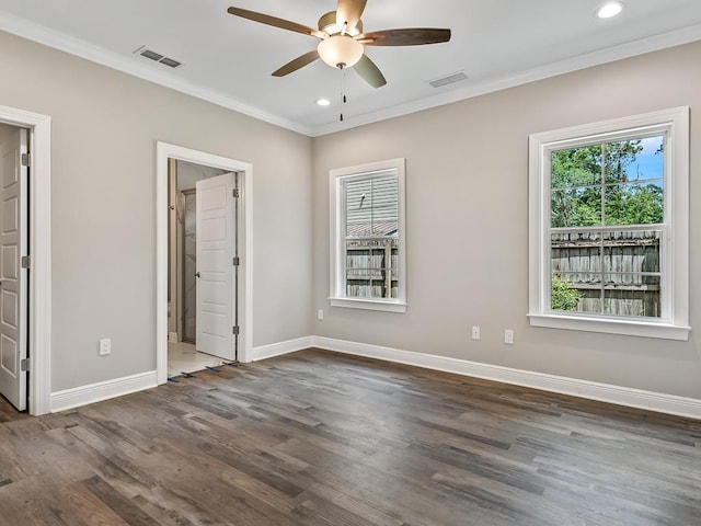 unfurnished bedroom with ceiling fan, ornamental molding, and dark wood-type flooring