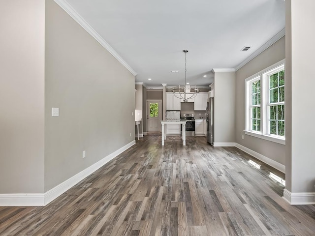 unfurnished living room with an inviting chandelier, dark hardwood / wood-style floors, and ornamental molding