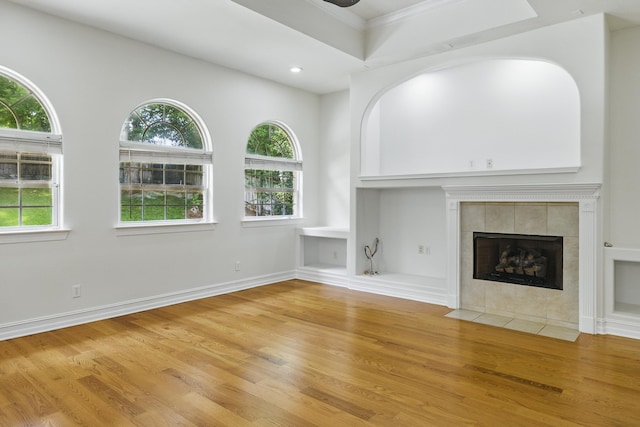 9227 Shoal Creek Dr, Tallahassee, FL 32312 - unfurnished living room featuring wood finished floors, plenty of natural light, ornamental molding, a tiled fireplace, and recessed lighting
