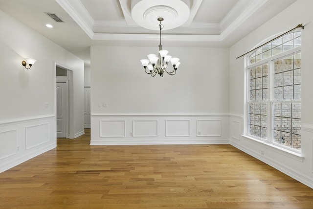 9227 Shoal Creek Dr, Tallahassee, FL 32312 - unfurnished dining area featuring a chandelier, plenty of natural light, crown molding, wainscoting, and light wood-type flooring