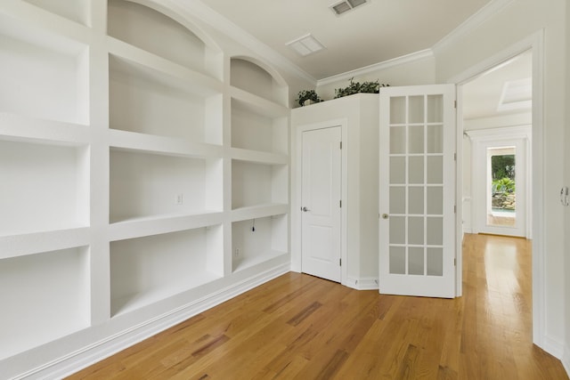 9227 Shoal Creek Dr, Tallahassee, FL 32312 - spare room with crown molding, wood finished floors, and built in features
