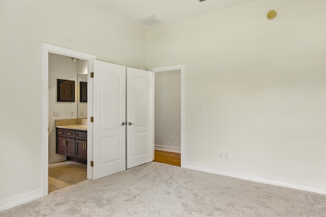9227 Shoal Creek Dr, Tallahassee, FL 32312 - unfurnished bedroom featuring light carpet, ensuite bathroom, and baseboards