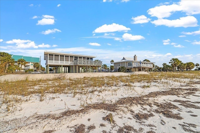 rear view of property with a sunroom