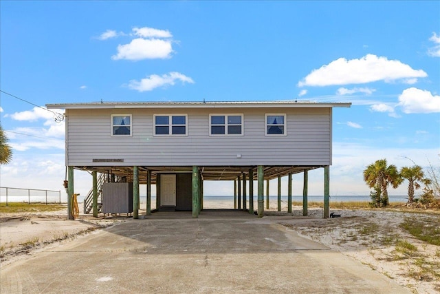 view of front of house with a carport and a water view