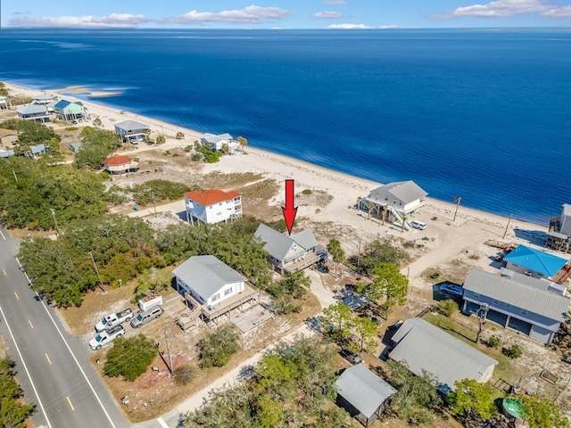 birds eye view of property with a view of the beach and a water view