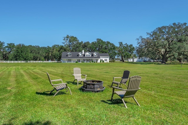 view of yard with fence and a fire pit