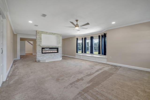 unfurnished living room with a large fireplace, ornamental molding, and light colored carpet