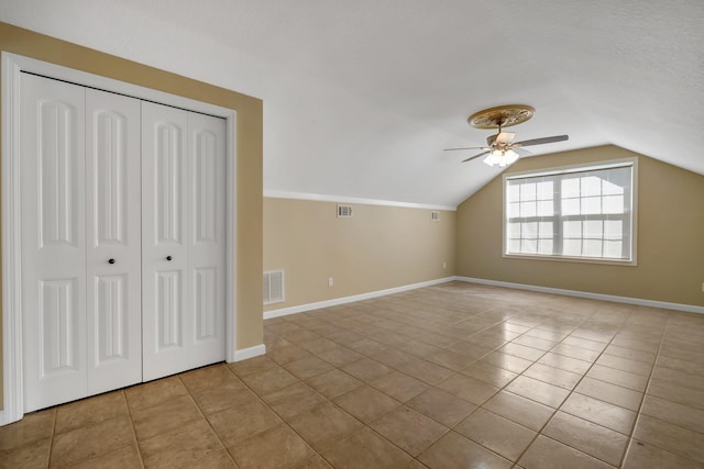 bonus room with visible vents, vaulted ceiling, baseboards, and light tile patterned floors