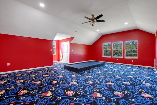 additional living space with lofted ceiling, carpet, baseboards, and ceiling fan