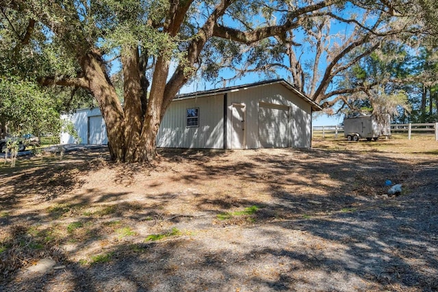 exterior space with an outdoor structure and fence