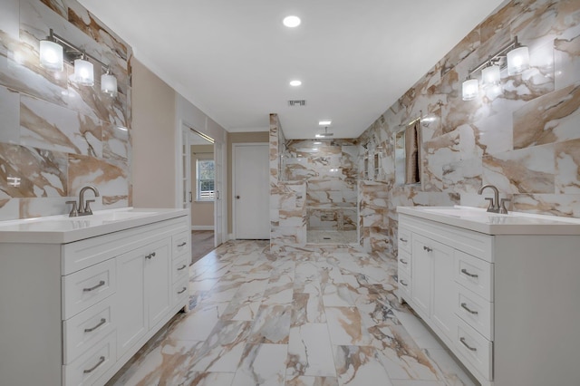 full bathroom featuring marble finish floor, ornamental molding, two vanities, and a sink