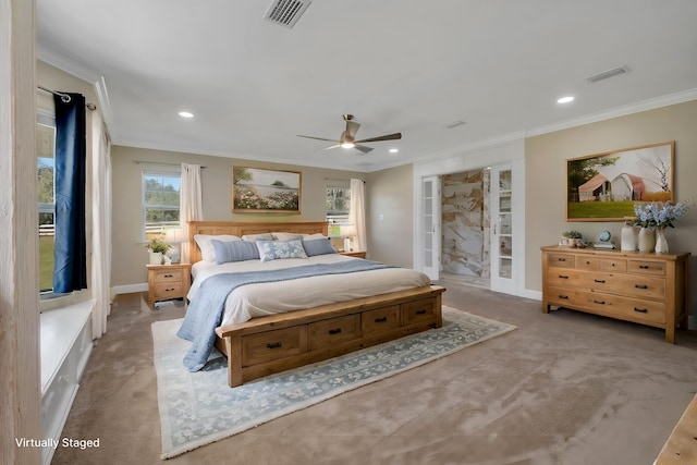 bedroom featuring light colored carpet, visible vents, and crown molding