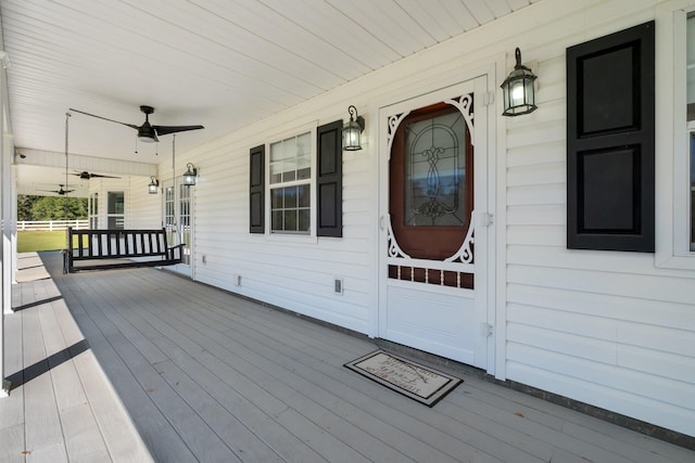 wooden deck featuring a porch and ceiling fan