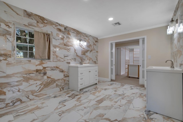 full bath with a sink, ornamental molding, two vanities, and visible vents