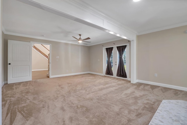 empty room featuring ornamental molding, light carpet, ceiling fan, and baseboards