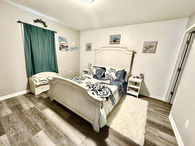 bedroom with dark wood-type flooring