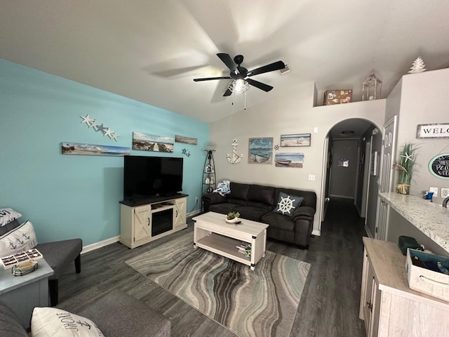 living room with ceiling fan, dark hardwood / wood-style floors, and vaulted ceiling