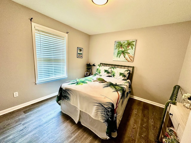 bedroom with dark hardwood / wood-style flooring