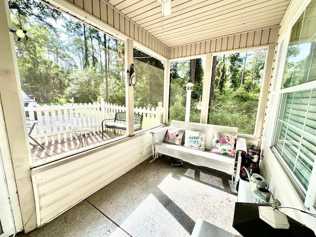 sunroom / solarium featuring wood ceiling