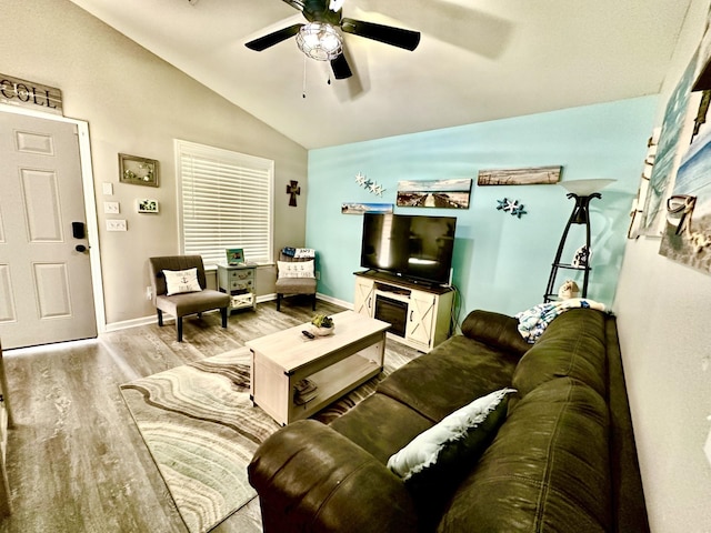 living room featuring light hardwood / wood-style flooring, lofted ceiling, and ceiling fan