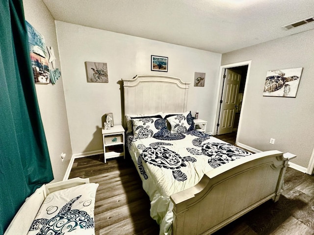 bedroom with dark wood-type flooring