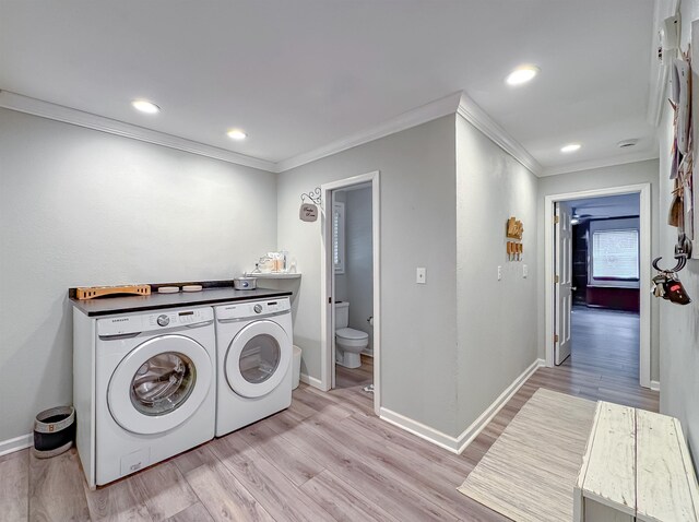 2825 Turkey Hill Trl, Tallahassee, FL 32312 - laundry area with washer and dryer, baseboards, crown molding, and light wood finished floors