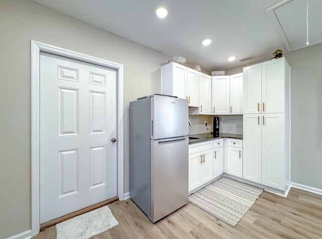 2825 Turkey Hill Trl, Tallahassee, FL 32312 - kitchen featuring light wood finished floors, freestanding refrigerator, white cabinetry, and visible vents