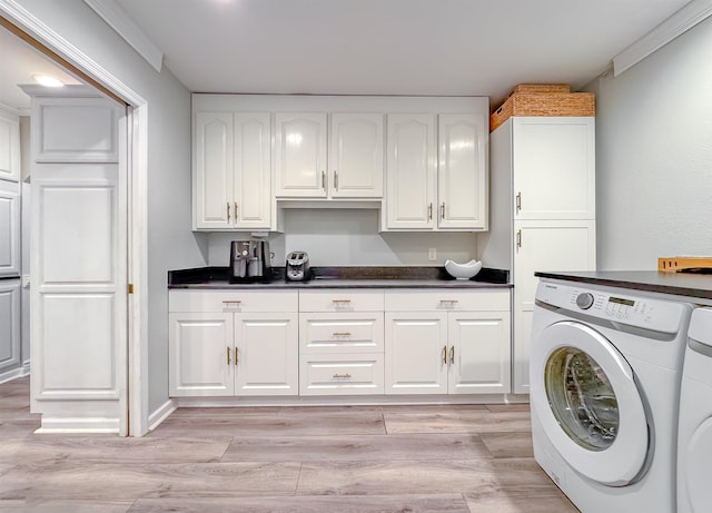 2825 Turkey Hill Trl, Tallahassee, FL 32312 - clothes washing area with washing machine and clothes dryer, cabinet space, and light wood-type flooring