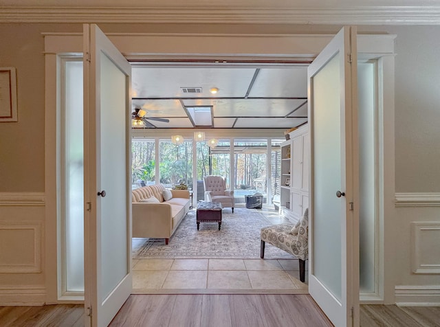 2825 Turkey Hill Trl, Tallahassee, FL 32312 - living room with visible vents, a ceiling fan, ornamental molding, light wood-type flooring, and a skylight