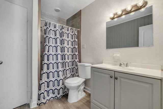 bathroom with vanity, wood-type flooring, curtained shower, and toilet