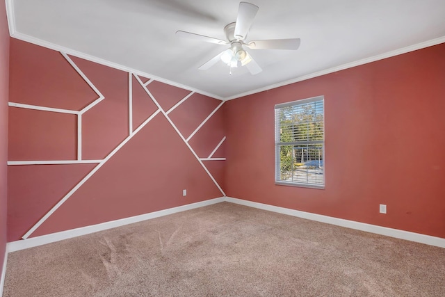 carpeted empty room with ornamental molding and ceiling fan