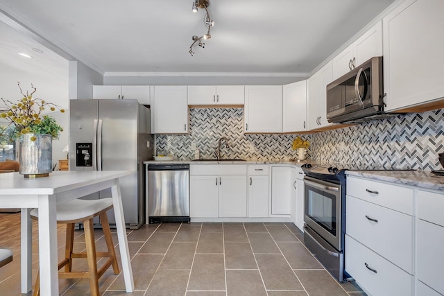 kitchen with white cabinetry, appliances with stainless steel finishes, sink, and light tile patterned flooring