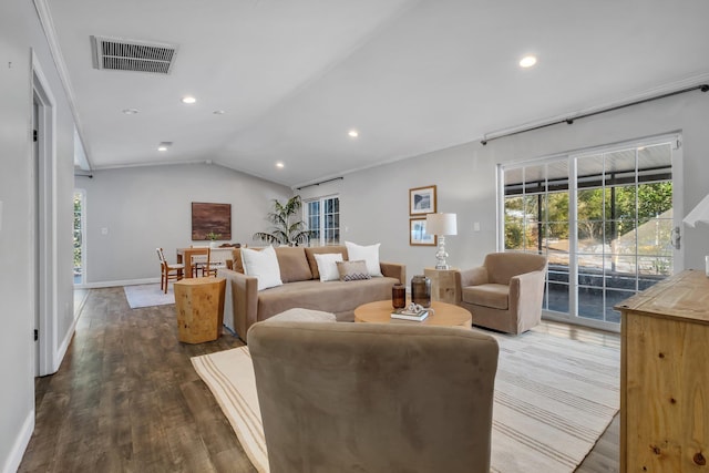 living room with crown molding, dark hardwood / wood-style flooring, and vaulted ceiling