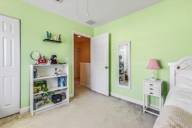 bedroom with baseboards, visible vents, and light colored carpet