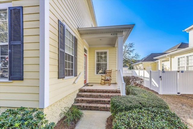 doorway to property featuring fence