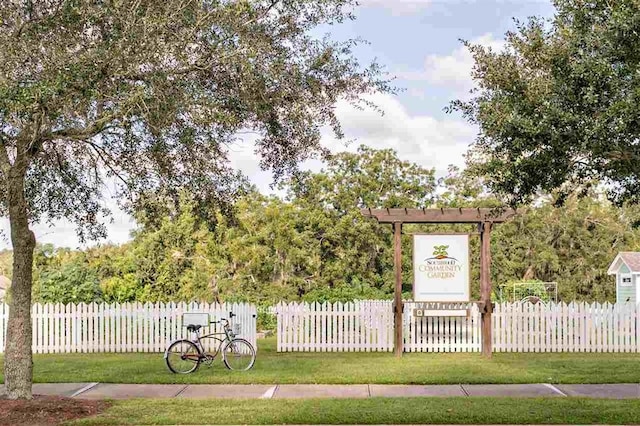 exterior space with fence and a lawn