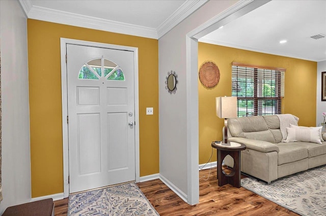 entrance foyer featuring ornamental molding, wood finished floors, and visible vents