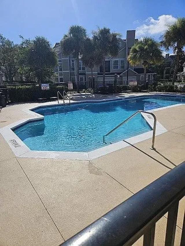 view of swimming pool with a patio