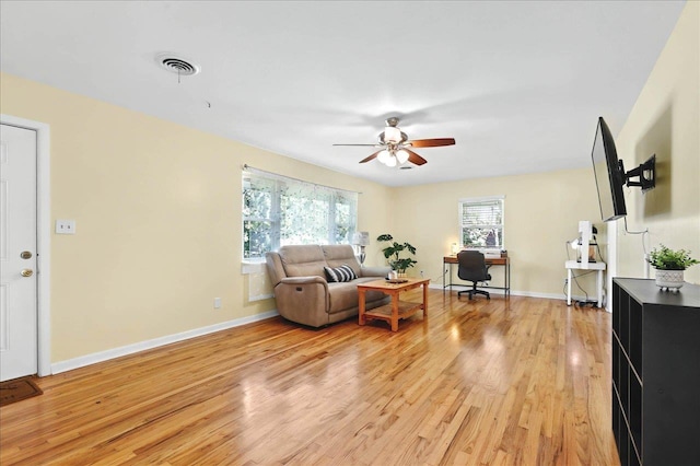 living room featuring ceiling fan and light wood-type flooring