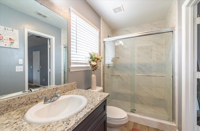 489 Charles Willis Dr, Midway, FL 32343 - full bath with a marble finish shower, toilet, vanity, and wood finished floors